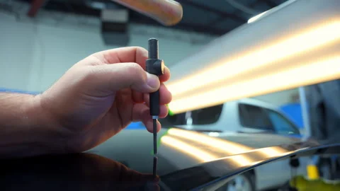 Close up shot view of Process of pointless dent repair on car body, mechanic at Stock-Footage 312246597