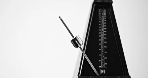 Close-up shot of vintage metronome with pendulum beats slow rhythm on the gray Vídeos de archivo 97171984