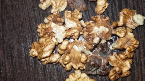 A close-up shot of the walnut kernel reveals the flavorful Stock Footage 329942295