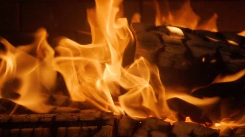 Close-up shot of warm cozy burning fire in a brick fireplace. Slow motion. HD Stock Footage 83387226