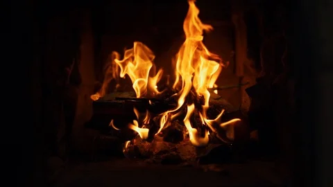Close-up shot of warm cozy burning fire in a brick fireplace. Slow motion Stock Footage 130167191