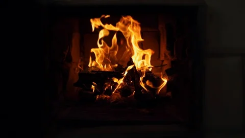 Close-up shot of warm cozy burning fire in a brick fireplace Stock Footage 130167362