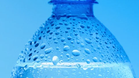 Close shot of water drops on bottle surface. Dolly shot of bottle of table water Stock Footage 127608648