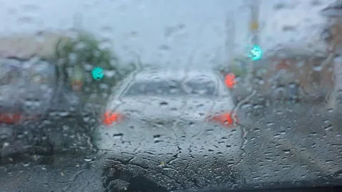 This is a close up shot of water drops gently falling on car glass and running Video stock 93062415