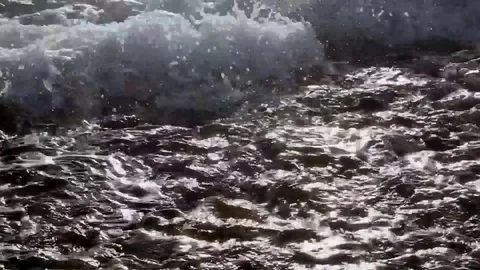 Close up shot of waves rolling over stones on the beach. Red Sea. Stock Footage 82685551
