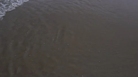 Close Up Shot of Waves Rolling Up Sand Beach Stock Footage 246957531