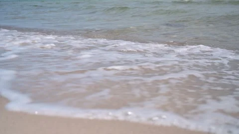 Close Up Shot of Waves Rolling Up A Sandy Beach. A Relaxing Oceanic Video. Stock Footage 246731725