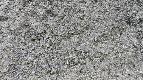 Close-up shot of weathered concrete surface with textured patterns and ligh.. Stock Photos