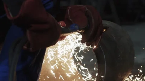 Close-up shot of welder's hand in protective gloves cuts pipe with cutting torch Stockbeeldmateriaal 143657845