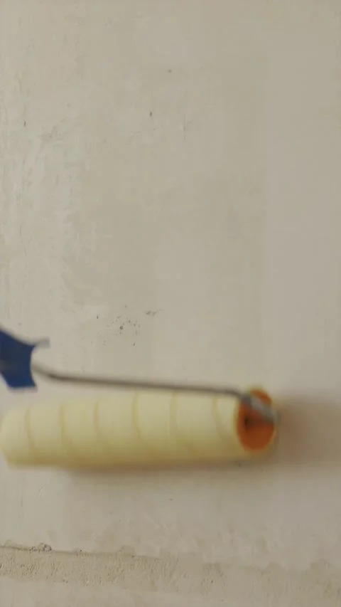 Close up shot of wet roller applying primer liquid onto wall Stock Footage 340404930