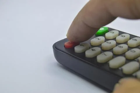 Close-up shot while pressing the remote control on a white background Stock Photos