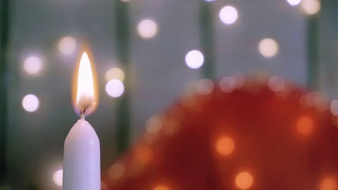 Close-up shot of white candle with fire on background with lights in bokeh. Stock-Footage 85283548