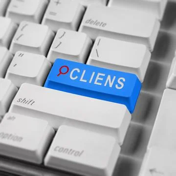 A close-up shot of a white computer keyboard featuring a prominent blue key.. Stock Photos