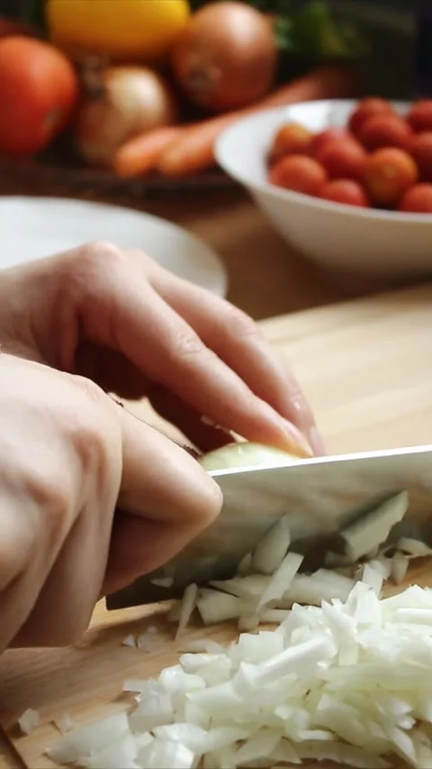 Close-up shot of white onion being diced on a bamboo cutting board. Stock Footage 303842501