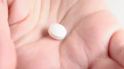 Close up shot of white pills falling into palm of hand. Healthcare, medical.. Stock Footage 267879058