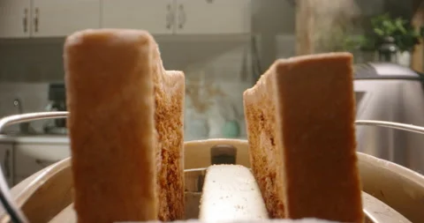 Close up shot of white sliced bread popping out of toaster with water steaming Stock Footage 158706549