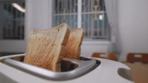 Close up shot of white sliced bread popping out of toaster, Slow motion Stock Footage 230398865