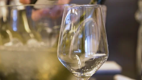Close up shot, white wine being poured into wine glass. Stock Footage 120844187