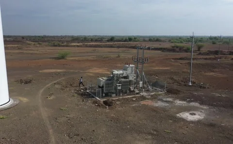 Close Up Shot of Wind Turbine Base Tower and Electrical Transformer Substation Stock Footage 341710199