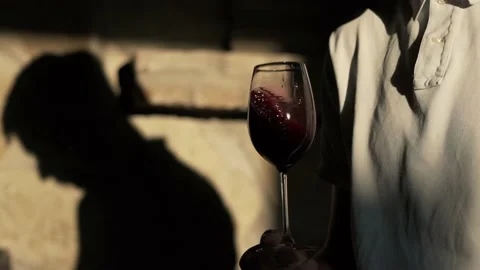 Close up shot winemaker or sommelier is pouring red wine in transparent glass Video stock 238542386