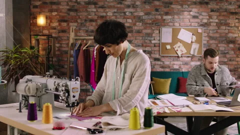 A close up shot of a woman doing patchwork on a sewing machine and looking very Stock Footage 200876094