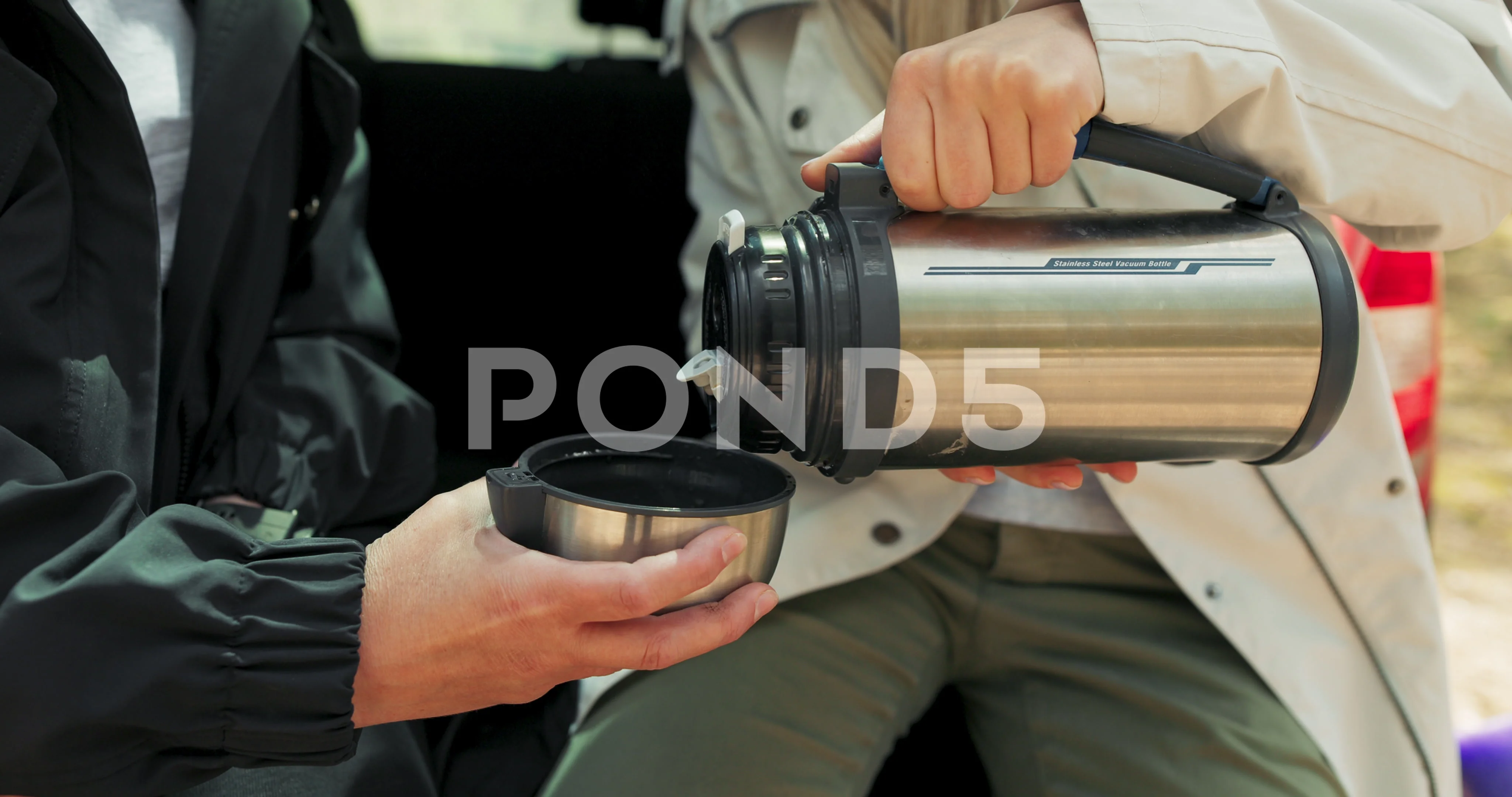 Crop Woman Pouring Hot Drink From Thermos by Stocksy Contributor