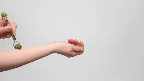 Close up shot of a woman using jade roller on her hand. 4k, slow motion. Stock Footage 238613084