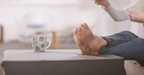 Close shot of womans feet while putting a book aside Video stock 102135984