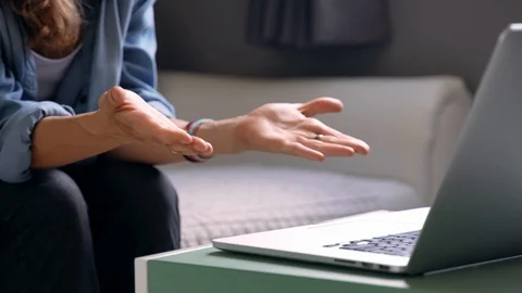 Close Up shot of woman's hand gesturing in front of the laptop. Stock-Footage 122608572