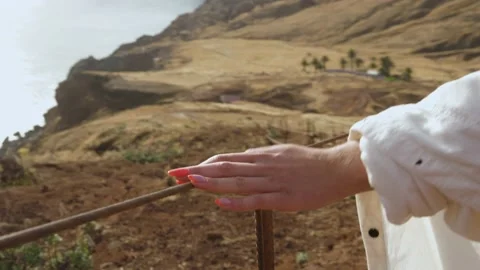 Close-up shot of a woman's hand gliding over a fence while walking Видео 167589369