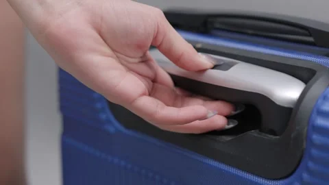 Close up shot of a woman's hand pulling out suitcase handle and walking away. Stock Footage 338425711