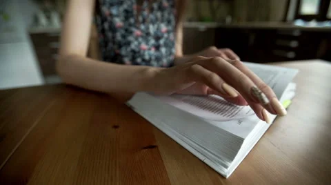 Close up shot of woman's hand reading a book indoors Stock Footage 66165505