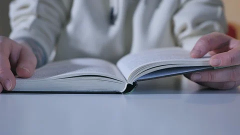 Close up shot of woman's hand reading a book indoors Stock Footage 101262414