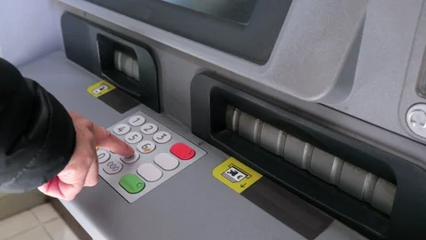Close up shot of a woman's hand typing her pin security code on an ATM Stock Footage 124608531