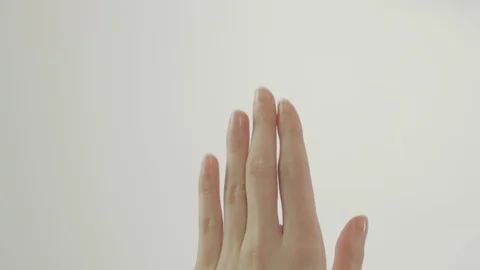 Close up shot of a womans hand in a white studio touching on an invisible screen Stock Footage 85902093