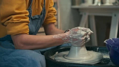 Close-up shot of a woman's hands making ceramic pottery on the pottery wheel. Stock Footage 141640523