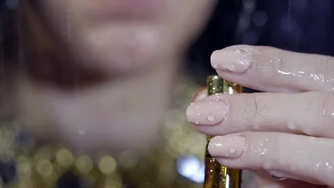Close up shot of a woman's hands opening parfume. Video stock 80999897
