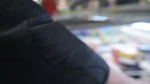Close-up shot of a womans hands opening a supermarket refrigerator, revealing Stock Footage 314770626