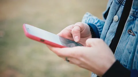 Close-up shot of woman's hands texting on her smartphone Stock Footage 170746910