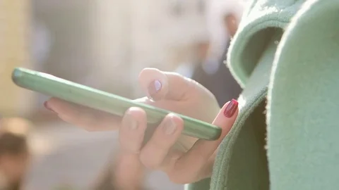Close-Up Shot Of Woman's Hands Using mobile phone In Busy Public Place Stock Footage 81288511