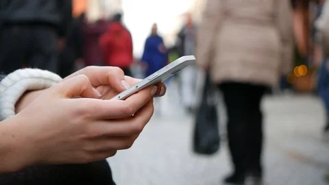 Close-Up Shot Of Woman's Hands Using mobile phone In Busy Public Place Vídeos de archivo 88712885