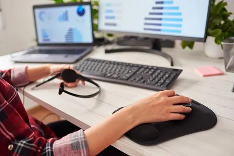 Close up shot of a woman's hands using the mouse on a computer Stock Photos