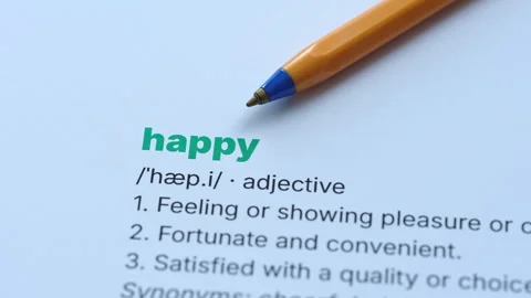 A close-up shot of the word Happy defined in a dictionary. Stock Footage 336917162
