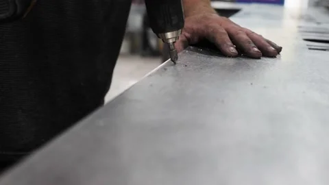 Close-up Shot Of A Worker Drilling A Hole On A Metal Sheet Stock-Footage 134422411