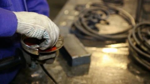 Close up shot worker with grinder grinds metall with sparks Stock Footage 67093152
