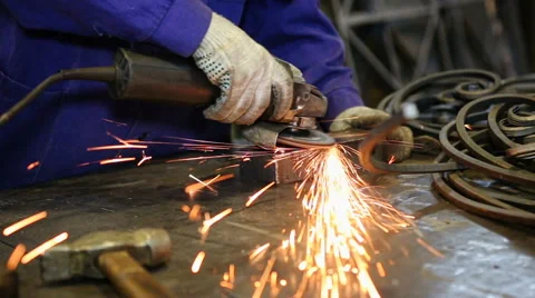 Close up shot worker with grinder grinds metall with sparks Stock Footage 67093970
