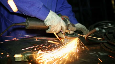 Close up shot worker with grinder grinds metall with sparks Stock Footage 67094017