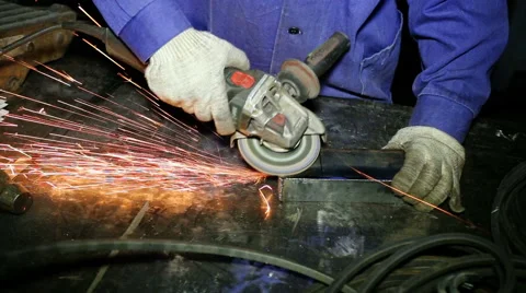 Close up shot worker with grinder grinds metall with sparks Stock Footage 67094132