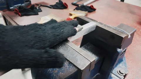 Close up shot of a worker hand file a metal in a factory. Shot in 4K. Stock-Footage 102569809