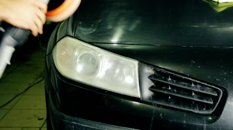 Close up shot worker polish car headlight with special tools Stock Footage 65758359
